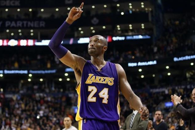 Dec 7, 201 Los Angeles Lakers guard Kobe Bryant (24) salutes the crowd reaction as he exits the game for the last time in Canada against the Toronto Raptors at Air Canada Centre. The Raptors beat the Lakers 102-93. Tom Szczerbowski-USA TODAY Sports